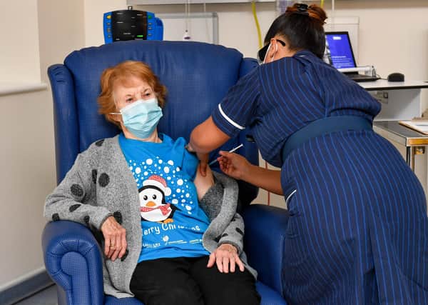 Margaret Keenan, 90, was the first patient in the United Kingdom to receive the Pfizer/BioNtech covid-19 vaccine at University Hospital, Coventry, administered by nurse May Parsons, at the start of the largest ever immunisation programme in the UK's history. (Photo by Jacob King - Pool / Getty Images)