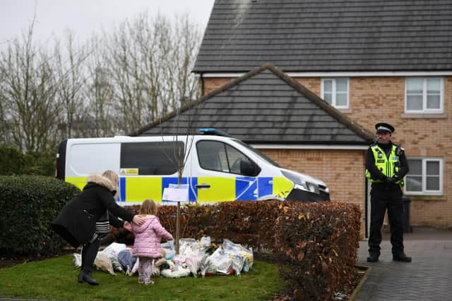 Floral tributes are left at the scene of a house fire on Buttercup Avenue, Eynesbury, Cambridgeshire, in which a three-year-old boy and a seven-year-old girl died. A 35-year-old woman and a 46-year-old were also injured in the fire at the three-storey house, which police believe broke out around 7am Thursday morning. EMN-201112-163022001