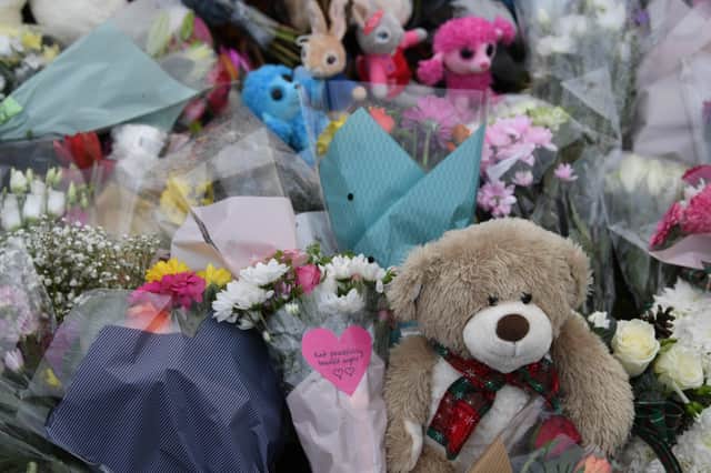 Floral tributes at the scene of a house fire on Buttercup Avenue, Eynesbury, Cambridgeshire, in which a three-year-old boy and a seven-year-old girl died. A 35-year-old woman and a 46-year-old were also injured in the fire at the three-storey house, which police believe broke out around 7am Thursday morning. EMN-201112-163643001