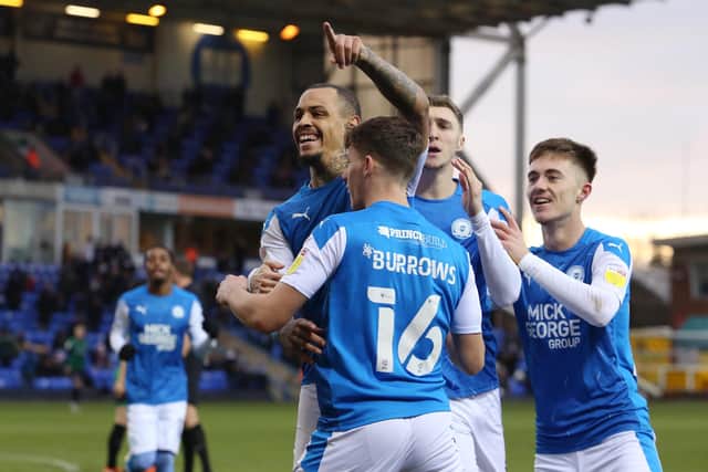 Jonson Clarke-Harris of Peterborough United celebrates scoring the opening goal with team-mates . Photo: Joe Dent/theposh.com