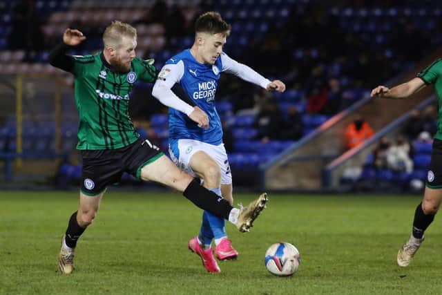 Flynn Clarke of Peterborough United in action with Stephen Dooley of Rochdale. Photo: Joe Dent/theposh.com.