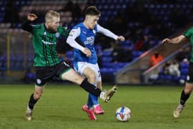Flynn Clarke of Peterborough United in action with Stephen Dooley of Rochdale. Photo: Joe Dent/theposh.com.