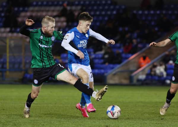 Flynn Clarke of Peterborough United in action with Stephen Dooley of Rochdale. Photo: Joe Dent/theposh.com.