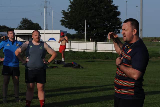 New Borough coach Shane Manning addresses his players at Fengate.