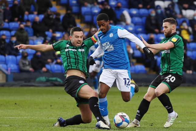 Reece Brown (centre) in action for Posh against Rochdale at the Weston Homes Stadium last weekend. Photo: Joe Dent/theposh.com.