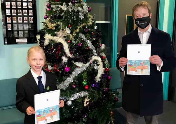 PaulBristow with Kaitlyn from the Thomas Deacon Academy who designed the MP's Christmas card.
