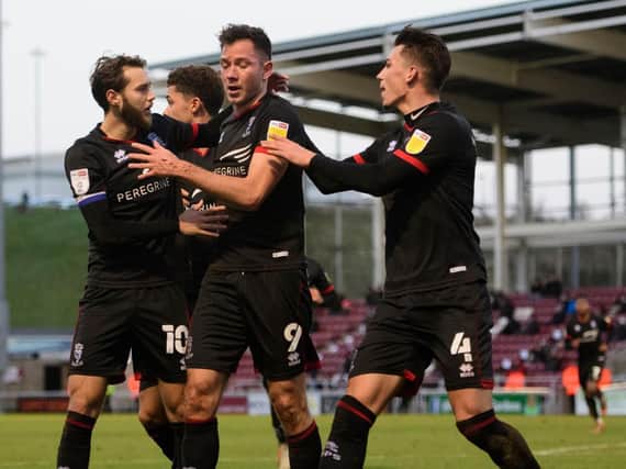 Lincoln City were 4-0 winners at Northampton Town to go level on points with league one leaders Portsmouth