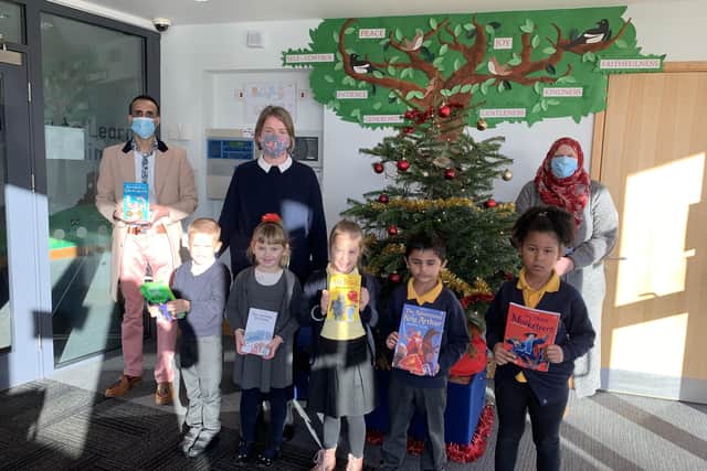 Labour councillors Shaz Nawaz (left) and Aasiyah Joseph (right) at All Saints' Church of England Primary School delivering some of the reading books