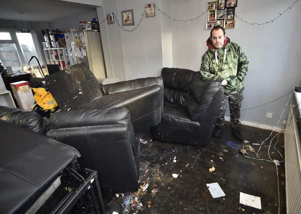 Daniel Shelton at his flooded home at Slade Close, Ramsey