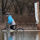 A cyclist battles through floodwater at Orton as the River Nene burst its banks in Peterborough. Picture: Paul Marriott