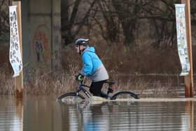 A cyclist battles through floodwater at Orton as the River Nene burst its banks in Peterborough. Picture: Paul Marriott
