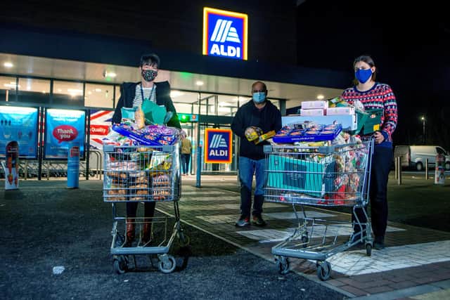 Rebecca Woolman, store manager at ALDI, Grange Park Retail Park, Loughborough, with Sally Myatt and Sash Baria, from the Adulam Housing Association, collecting some of the food donations at the store on Christmas Eve.