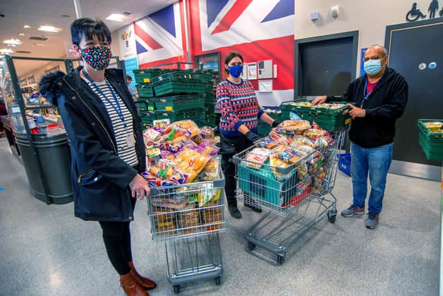 Rebecca Woolman, store manager at ALDI, Grange Park Retail Park, Loughborough, with Sally Myatt and Sash Baria, from the Adulam Housing Association, collecting some of the food donations at the store on Christmas Eve.