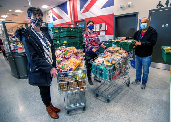 Rebecca Woolman, store manager at ALDI, Grange Park Retail Park, Loughborough, with Sally Myatt and Sash Baria, from the Adulam Housing Association, collecting some of the food donations at the store on Christmas Eve.