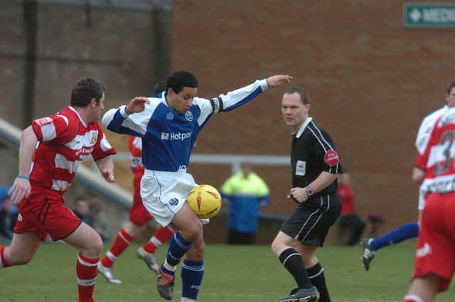 Curtis Woodhouse (blue shirt) in action for Posh.