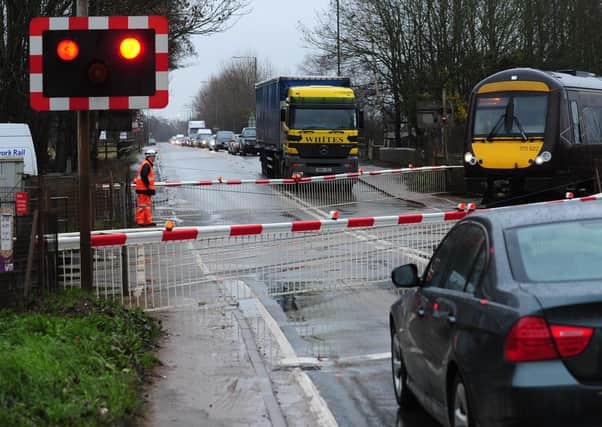 A barrier failure at Kings Dyke level crossing  is causing tailbacks on the A605. (archive image).