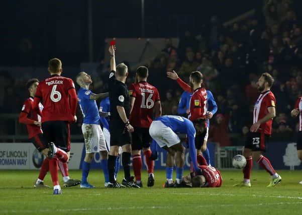 Siriki Dembele is shown a red card in Posh's defeat at Lincoln last season.