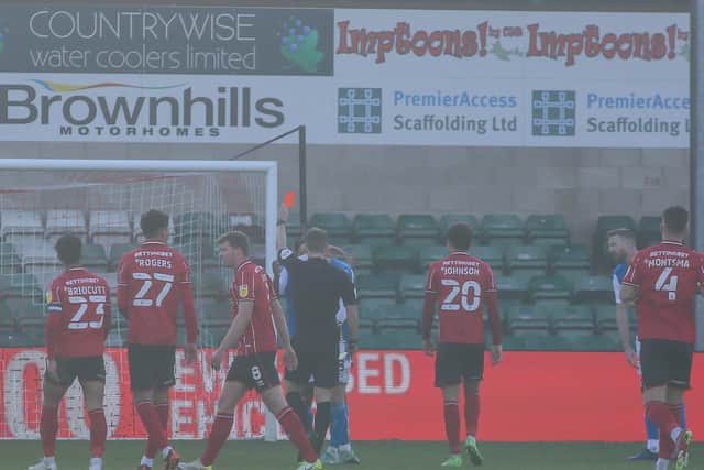 Posh defender Nathan Thompson is shown a red card by referee Will Finnie at Lincoln City. Photo: Joe Dent/theposh.com.