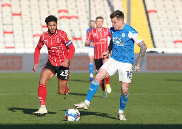 Sammie Szmodics of Peterborough United in action with Liam Bridcutt of Lincoln City at the weekend. Photo: Joe Dent/theposh.com.