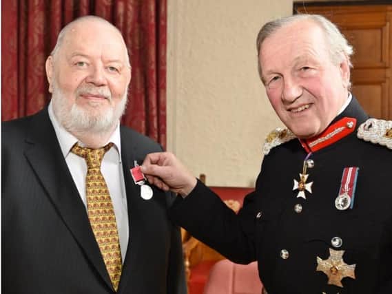 Brian Gascoyne is presented with his BEM by Sir Hugh Duberly, Lord Lieutenant