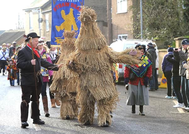 The annual Whittlesea Straw Bear Festival parade through the streets.