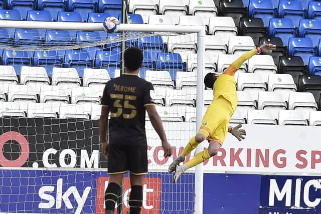 A long-range shot from Mk Dons' Regan Poole thuds against the Posh crossbar. Photo: David Lowndes.