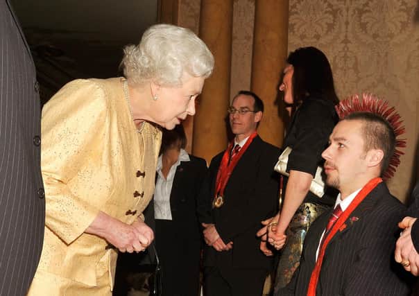 Queen Elizabeth II talks to Matt Skelhon at a reception for the 2008 GB Paralympic team.