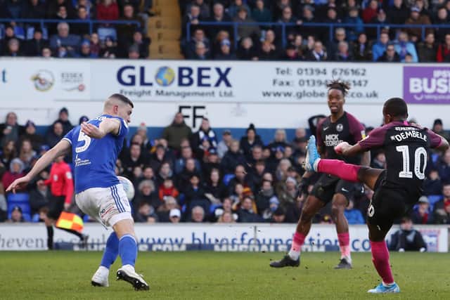 Siriki Dembele scores for Posh at Ipswich last season.