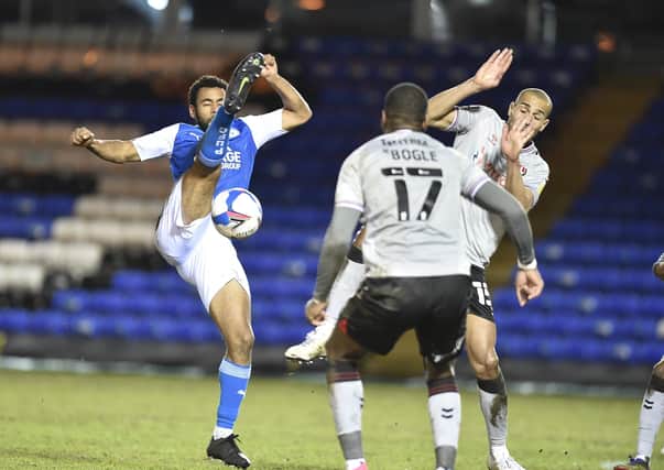 Posh defender Nathan Thompson and Charlton's Darren Pratley (right) battle for the ball. Photo: David Lowndes.