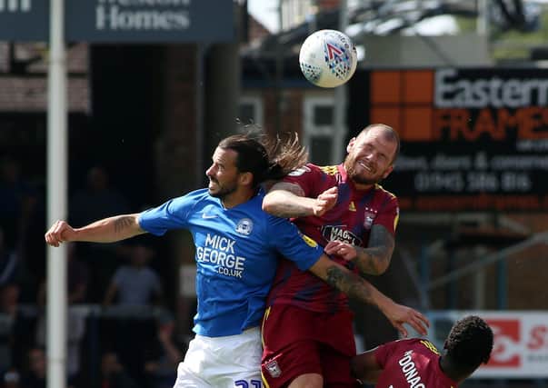 James Norwood (centre) in action for Ipswich at Posh last season.