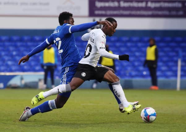 Siriki Dembele of Peterborough United is fouled by Aristote Nsiala of Ipswich Town for a penalty. Photo: Joe Dent/theposh.com.