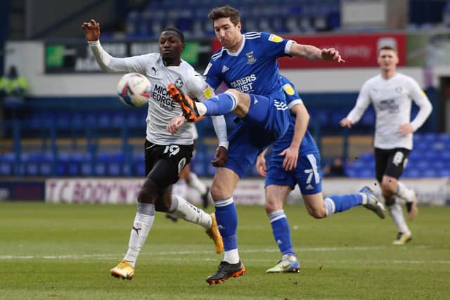 Idris Kanu of Peterborough United battles with Stephen Ward of Ipswich Town. Photo: Joe Dent/theposh.com.