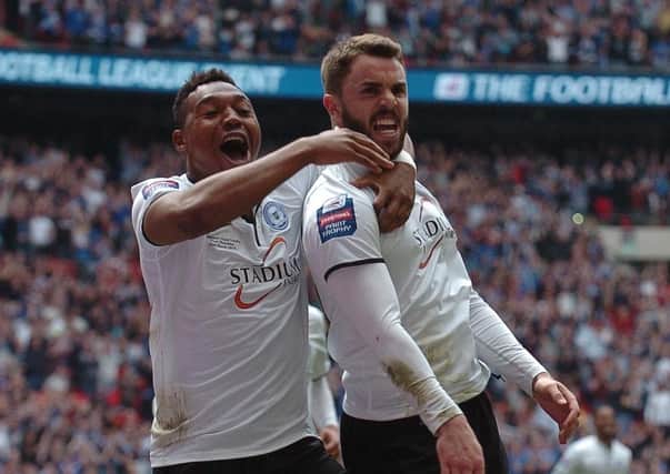 Josh McQuoid celebrates his goal for Posh at Wembley in the 2014 JPT Trophy Final with Britt Assombalonga.