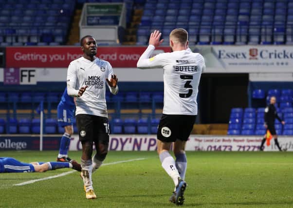 Idris Kanu (left) celebrates the winning goal for Posh at Ipswich with Dan Butler.