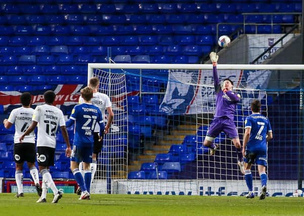 Posh goalkeeper Christy Pym tips a shot from Ipswich substitute Jon Nolan over the crossbar. Photo: Joe Dent/theposh.com.