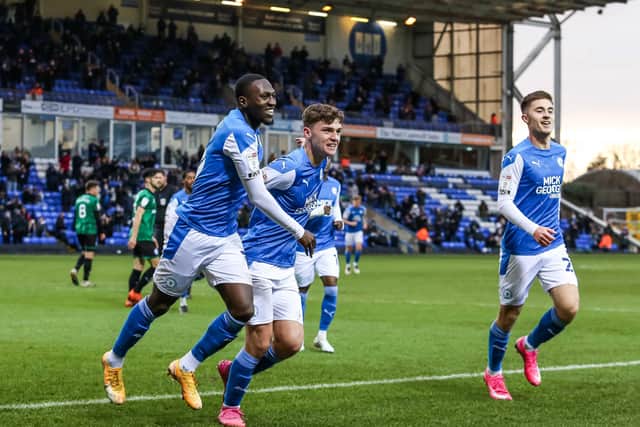 Harrison Burrows (centre) and Flynn Clarke (right) celebrate a Posh goal against Rochdale with Idris Kanu.