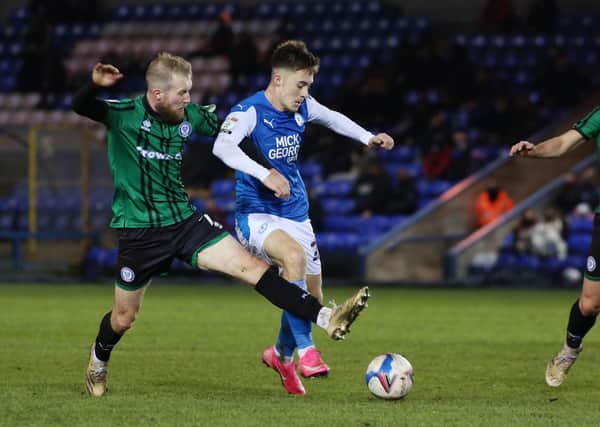 Flynn Clarke (blue shirt) in action for Posh against Rochdale in a League One game this season.