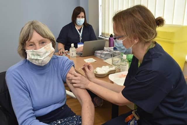 Jill Plant receives her jab from Dr Gillian Mitchell