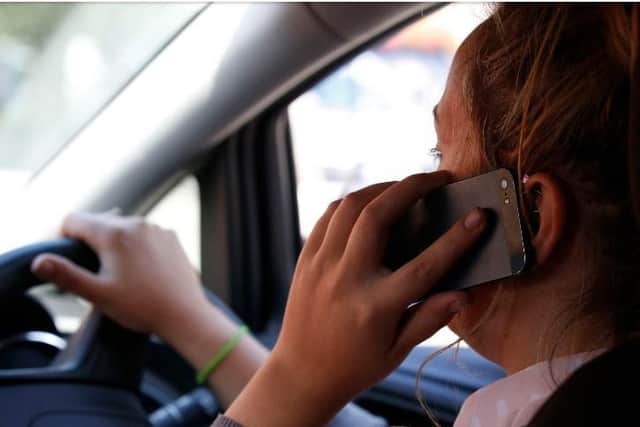 The dangers of using a mobile phone behind the wheel are being highlighted by police. Pic: Jonathan Brady/PA Wire
