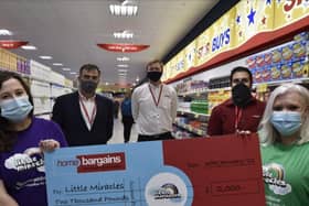 Emily Sibthorpe and Jill Bedward-Jones from Little Miracles receive a cheque from staff at Home Bargains, Craig Berridge, Graham Link and Bashir Irzaq