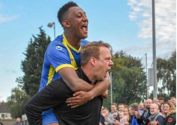 Peterborough Sports manager Jimmy Dean carrying star man Dion Sembie-Ferris.