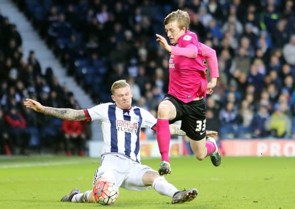 Chris Forrester of Peterborough United rides a tackle from James McClean of West Bromwich Albion. Photo: Joe Dnt/theposh.com.