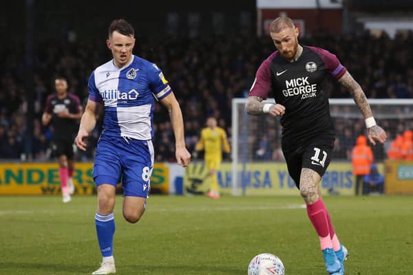 Marcus Maddison (right) in action for Posh.