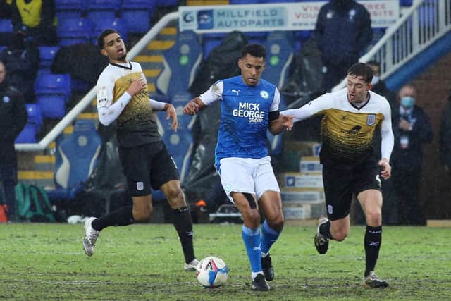 Nathan Thompson of Peterborough United in action with Mikael Mandron and Ryan Wintle of Crewe Alexandra. Photo: Joe Dent/theposh.com.
