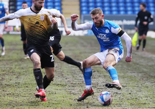 Dan Butler of Peterborough United takes on Luke Murphy of Crewe Alexandra. Photo: Joe Dent/theposh.com.