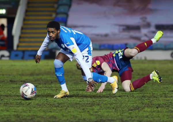 Reece Brown of Peterborough United wins the ball away from Teddy Bishop of Ipswich Town. Photo: Joe Dent/theposh.com.