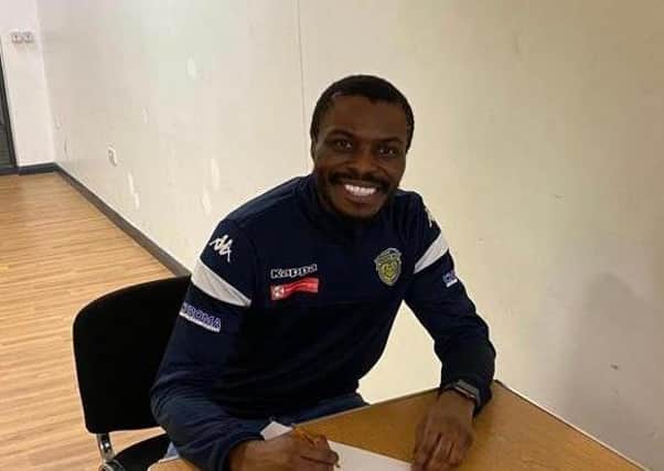 Gaby Zakuani signs on the dotted line again for Spalding United.