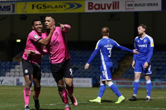 Jonson Clarke-Harris of Peterborough United celebrates scoring his second goal of the game with Nathan Thompson. Photo: Joe Dent/theposh.com.
