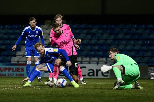 Posh skipper Mark Beevers wanted a penalty for this challenge by Connor Ogilvie. Photo: Joe Dent/theposh.com