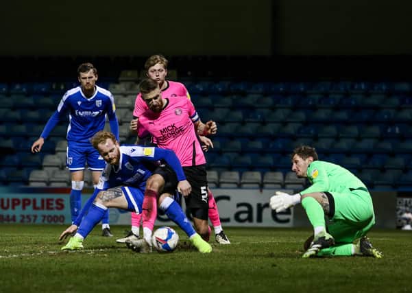 Posh skipper Mark Beevers wanted a penalty for this challenge by Connor Ogilvie. Photo: Joe Dent/theposh.com